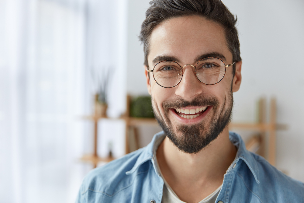 Close up shot of cheerful satisfied handsome male - Dental Fillings