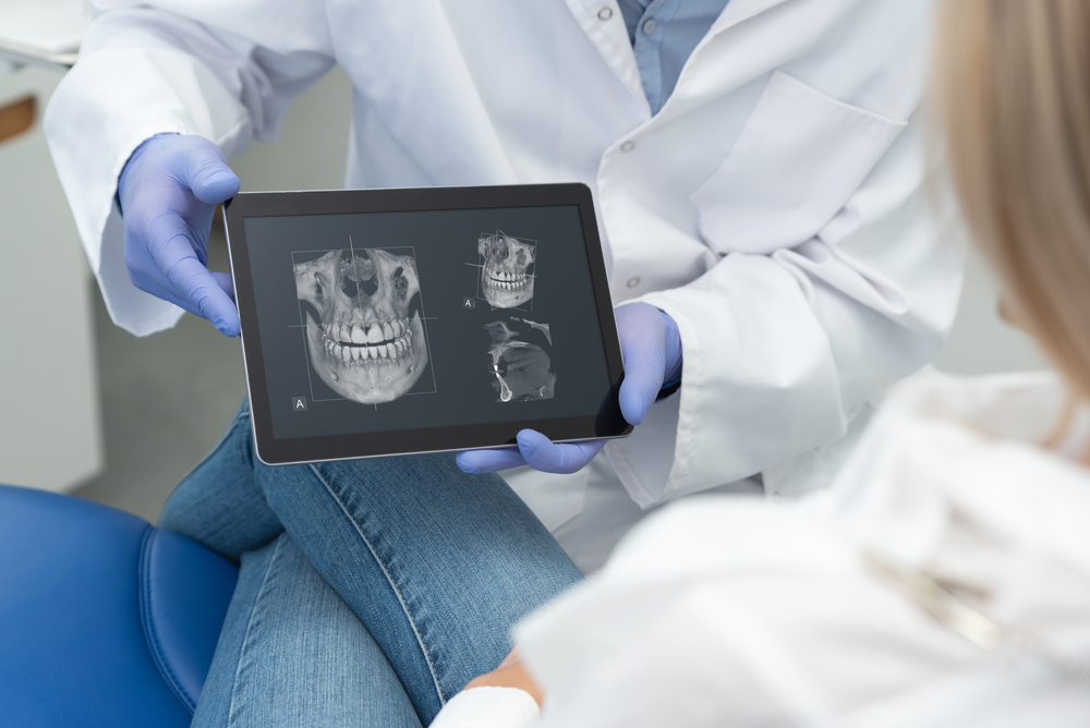 dentist showing dental x-rays
