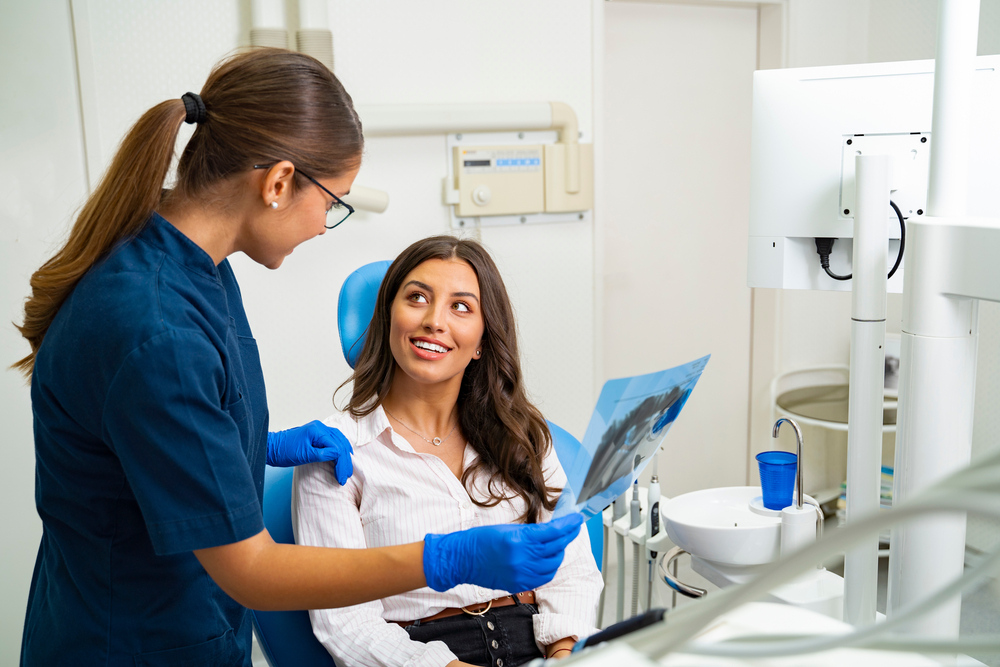 Dentist explaining to a female patient - Panoramic X-Rays
