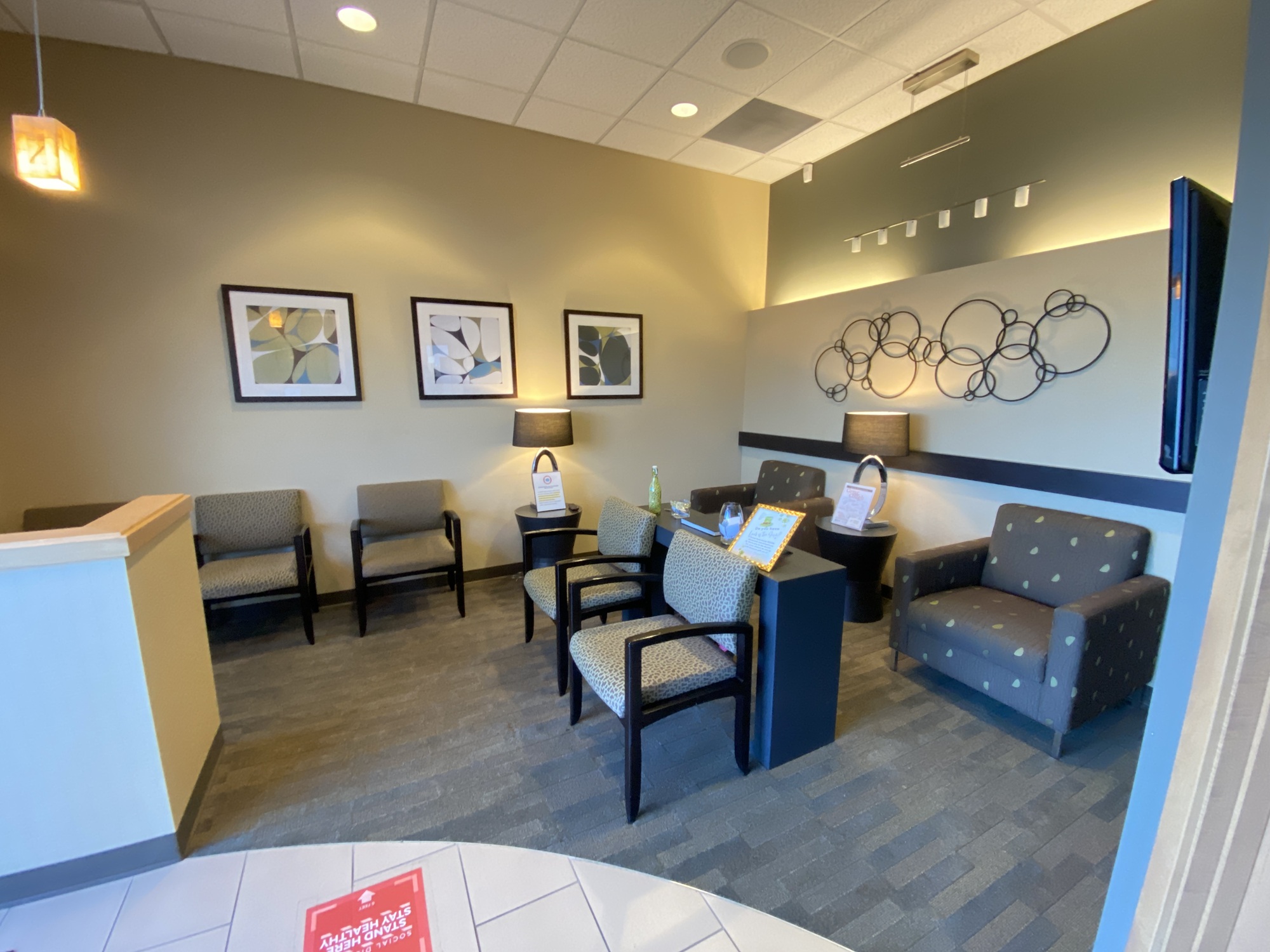 A clean and inviting dental office waiting area with contemporary seating and decor, providing a comfortable environment for patients receiving dental bonding – Dental Bonding