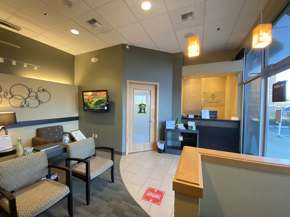A dental clinic waiting area with chairs, a reception desk, and warm lighting - Dentist Graham WA A dental clinic waiting area with chairs, a reception desk, and warm lighting - Dentist Graham WA