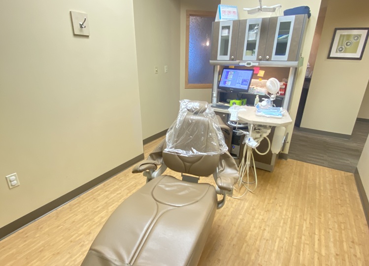A dental treatment room featuring a chair, equipment, and a monitor - Dentist Graham WA A dental treatment room featuring a chair, equipment, and a monitor - Dentist Graham WA
