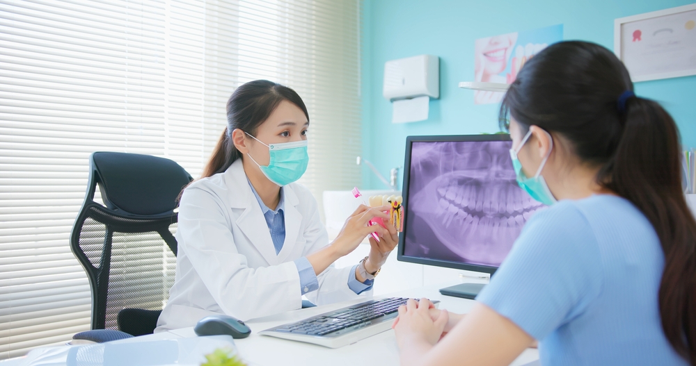 Dentist explaining to a female patient - Panoramic X-Rays