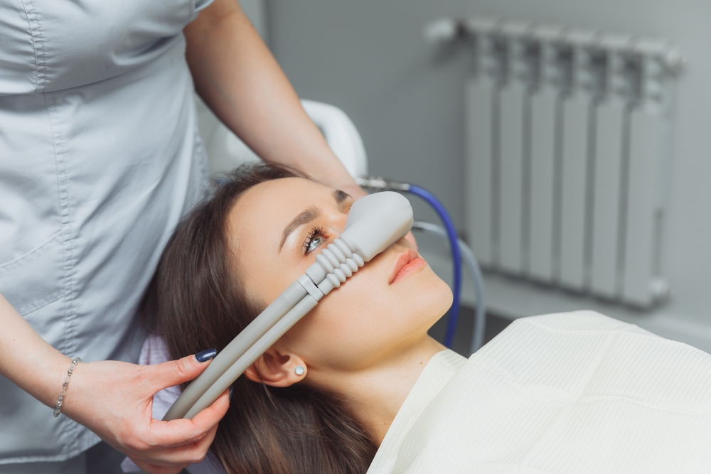 A patient receiving nitrous oxide sedation through a nasal mask during a dental procedure - Dentist Graham WA A patient receiving nitrous oxide sedation through a nasal mask during a dental procedure
